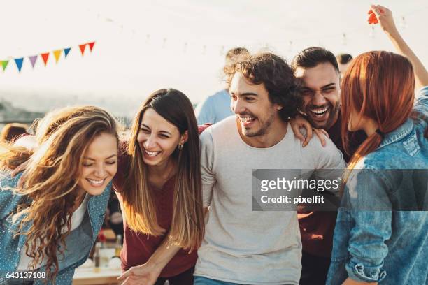ecstatic group enjoying the party - cheerful stock pictures, royalty-free photos & images