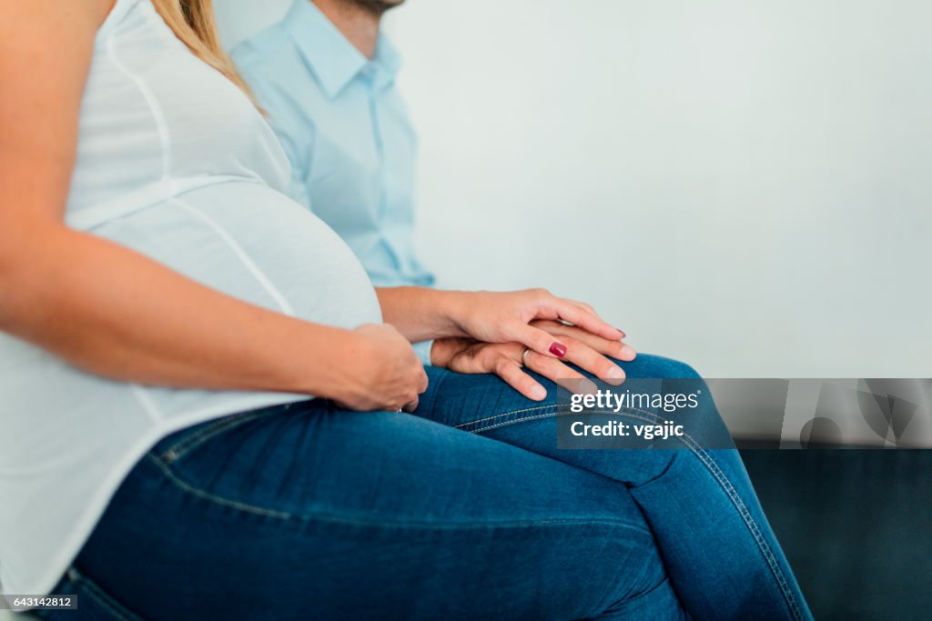 Pregnant woman and her man in doctor's office