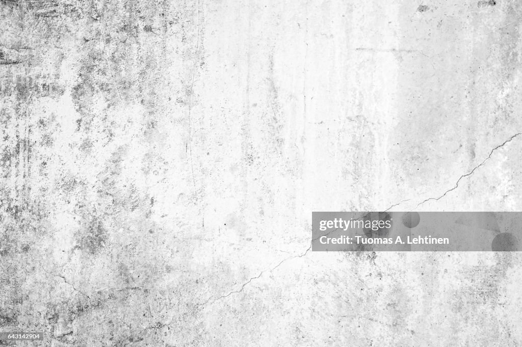 Worn concrete wall texture background with paint partly faded, in black&white.