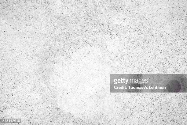 light gray concrete wall texture background, paint partly faded, in black&white. - ruffled stock-fotos und bilder
