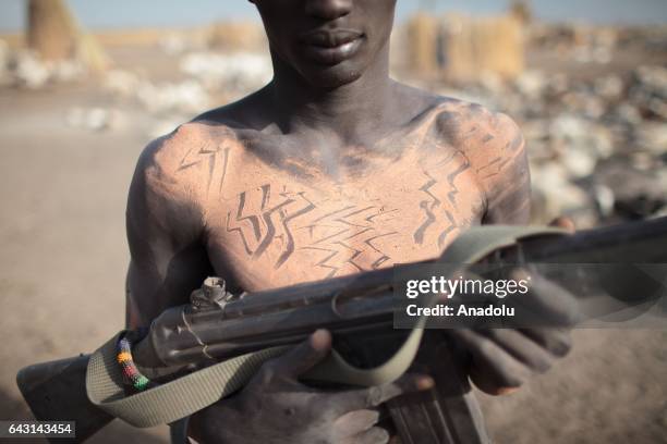 Mundari man is seen with his weapon in Terekeka town of Juba, South Sudan on February 9, 2017. Munda people, a small ethnic group of South Sudan,...