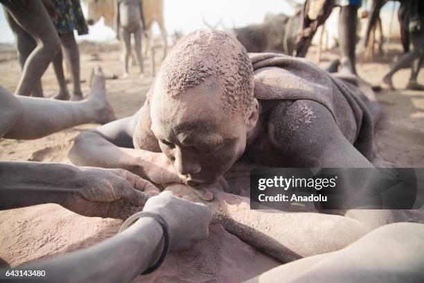 Mundari man covers his face and body with ash to protect himself from insects and mosquitos in Terekeka town of Juba, South Sudan on February 9,...