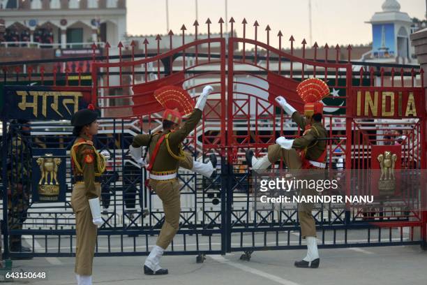 Indian Border Security Force personnel symbolically slam gates shut as they perform during the daily beating of the retreat ceremony on the...