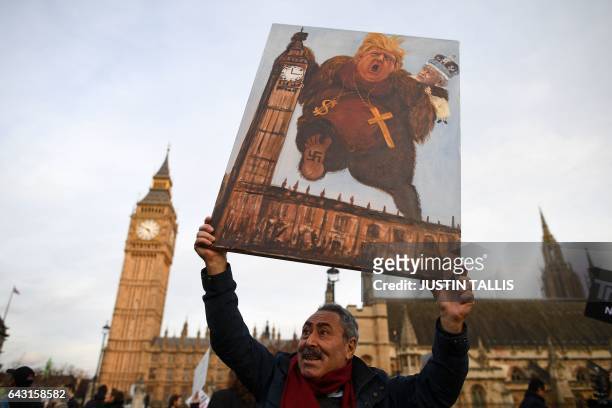 Satirical artist Kaya Mar poses with an artwork depicting President Trump and Queen Elizabeth in front of the Elizabeth Tower, better known as "Big...