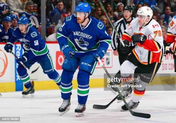 Jack Skille of the Vancouver Canucks and Micheal Ferland of the Calgary Flames skate up ice during their NHL game at Rogers Arena February 18, 2017...