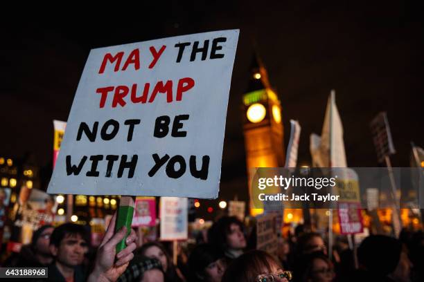 Protesters hold up a placard during a rally in Parliament Square against US president Donald Trump's state visit to the UK on February 20, 2017 in...