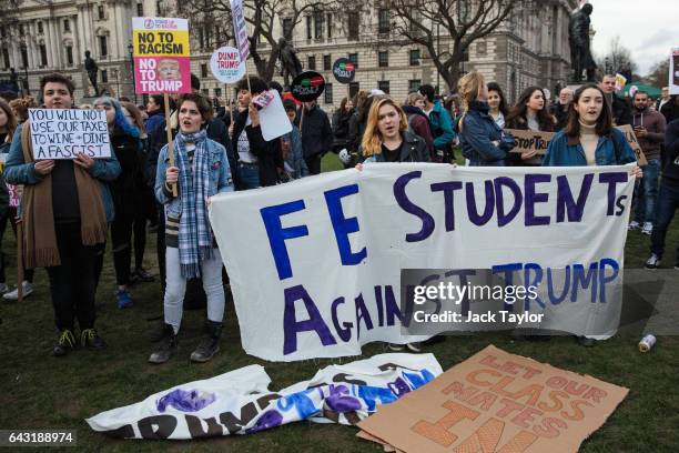 Student protesters hold up placards and a banner during a rally in Parliament Square against US President Donald Trump's state visit to the UK on...