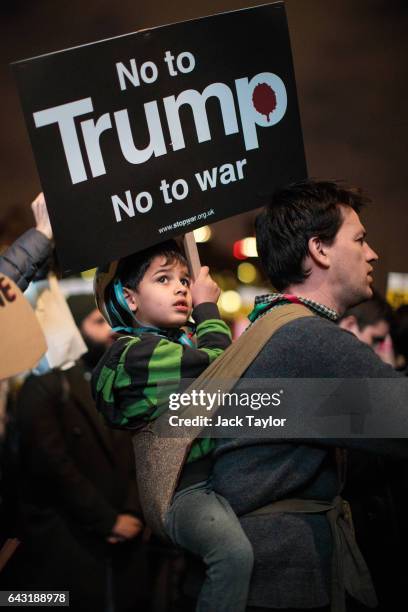 Young protester holds up a placard during a rally in Parliament Square against US President Donald Trump's state visit to the UK on February 20, 2017...