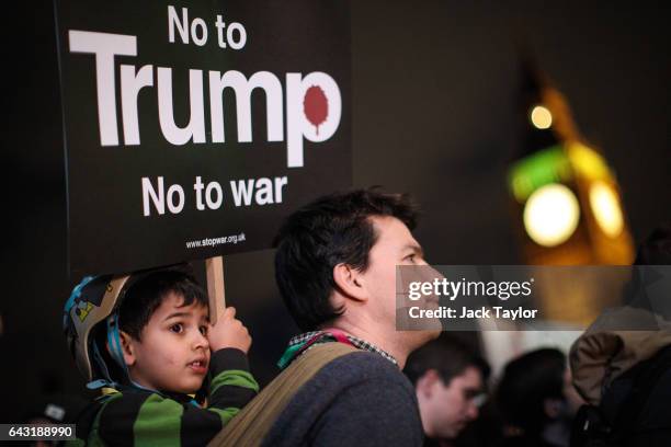 Young protester holds up a placard during a rally in Parliament Square against US President Donald Trump's state visit to the UK on February 20, 2017...
