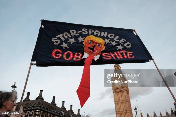 Banner depicting US President Donald Trump is held up during a rally in Parliament Square against his state visit to the UK on February 20, 2017 in...