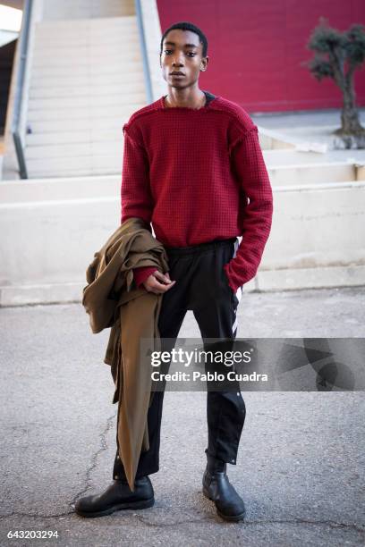 Model Luis Mba wears Bershka trousers , David Poza pullover, H&M coat and Capote Airwear glasses at Ifema during Mercedes Benz Fashion Week Madrid...