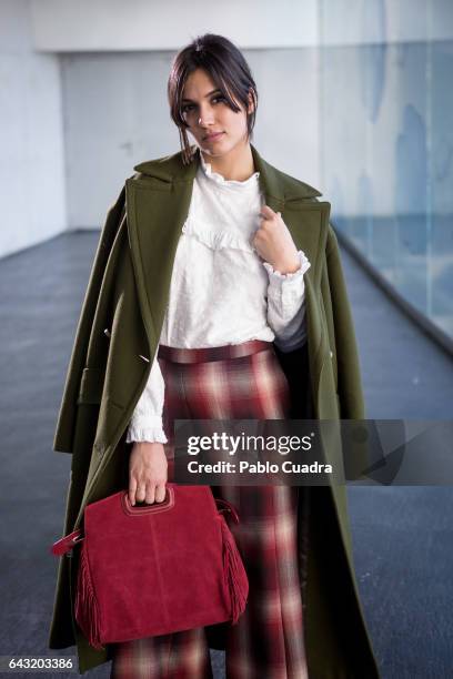 Actress Michelle Calvo wears Ursula Mascaro shoes, Angel Schlesser trousers, shirt and jacket and Maje handbag at Ifema during Mercedes Benz Fashion...