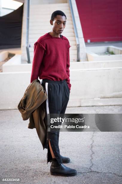 Model Luis Mba wears Bershka trousers , David Poza pullover, H&M coat and Capote Airwear glasses at Ifema during Mercedes Benz Fashion Week Madrid...