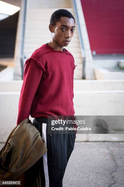 Model Luis Mba wears Bershka trousers , David Poza pullover, H&M coat and Capote Airwear glasses at Ifema during Mercedes Benz Fashion Week Madrid...