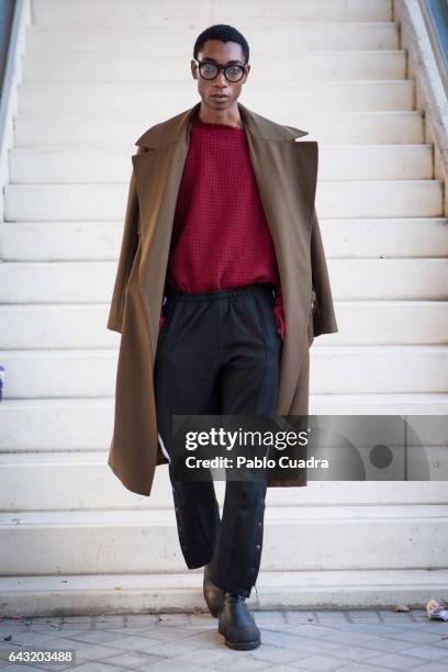 Model Luis Mba wears Bershka trousers , David Poza pullover, H&M coat and Capote Airwear glasses at Ifema during Mercedes Benz Fashion Week Madrid...