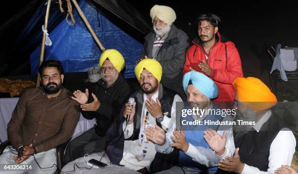 Candidate Gurdev Singh Mann singing a song outside the sealed 'strong room' where Electronic Voting Machines are kept at Govt. Physical College on...