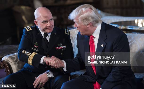 President Donald Trump shakes hands with US Army Lieutenant General H.R. McMaster as his national security adviser at his Mar-a-Lago resort in Palm...