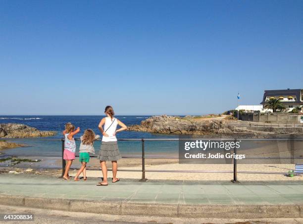 group of friends standing on the sidewalk looking out across the coast on a summer day - viana do castelo city stock pictures, royalty-free photos & images