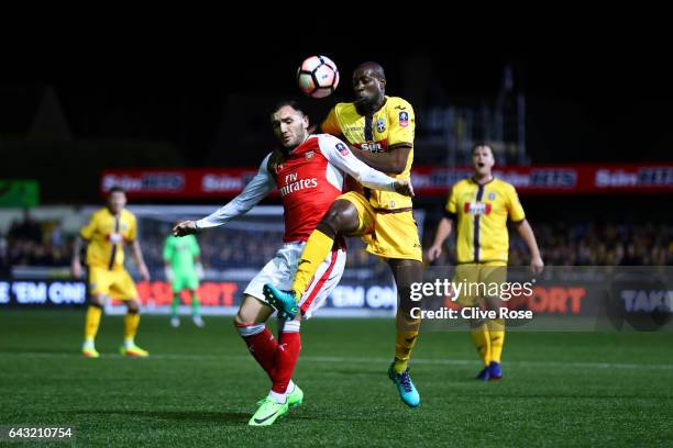 Bedsente Gomis of Sutton United battles for the ball with Lucas of Arsenal during the Emirates FA Cup fifth round match between Sutton United and...