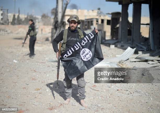 Free Syrian Army members remove Daesh flags as they move forward to the center of Al-Bab district during the "Operation Euphrates Shield" in Aleppo,...