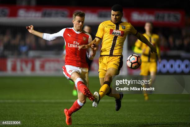 Rob Holding of Arsenal attempts to clear the ball under pressure from Maxime Biamou of Sutton United during the Emirates FA Cup fifth round match...