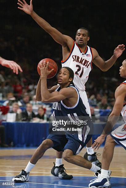 Guard Derrick Snowden of the Villanova Wildcats looks to pass while being pressured by guard DeShaun Williams of the Syracuse Orangemen during the...