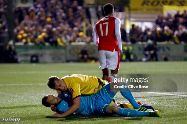Jamie Collins of Sutton United collides with David Ospina of Arsenal during the Emirates FA Cup fifth round match between Sutton United and Arsenal...