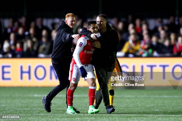 Alexis Sanchez of Arsenal is congratulated by fans on the pitch after the Emirates FA Cup fifth round match between Sutton United and Arsenal on...