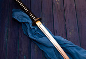 japan katana sword on the wood background with the blue shawl