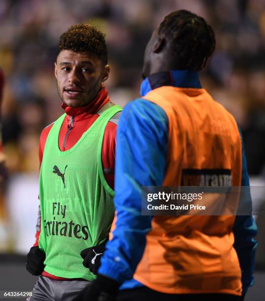 Alex Oxlade-Chamberlain of Arsenal chats to Jeffrey Monakana of Sutton as they warm up during the match between Sutton United and Arsenal on February...