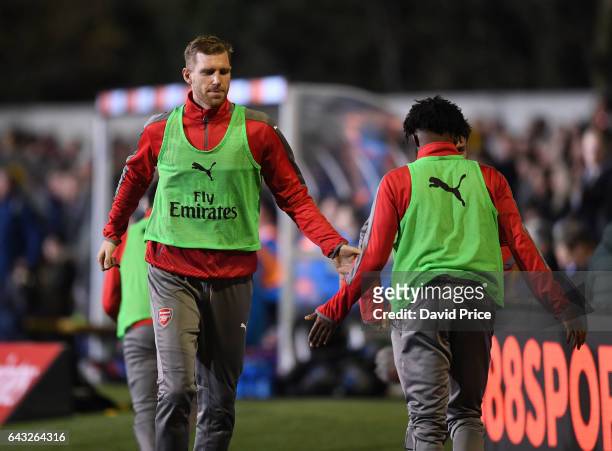 Per Mertesacker high fives with Ainsley Maitland-Niles of Arsenal as they warm up during the match between Sutton United and Arsenal on February 20,...