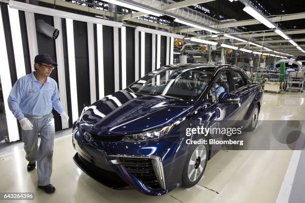 Toyota Motor Corp. Worker inspects a Mirai fuel-cell vehicle on the production line of the company's Motomachi plant in Toyota City, Aichi, Japan, on...