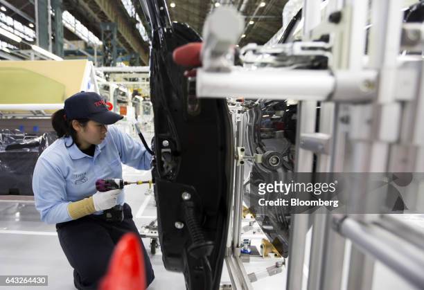 Toyota Motor Corp. Worker assembles a door of a Mirai fuel-cell vehicle on the production line of the company's Motomachi plant in Toyota City,...