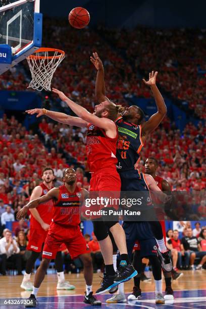 Jesse Wagstaff of the Wildcats and Tony Mitchell of the Taipans contest for a rebound during the game two NBL Semi Final match between the Perth...