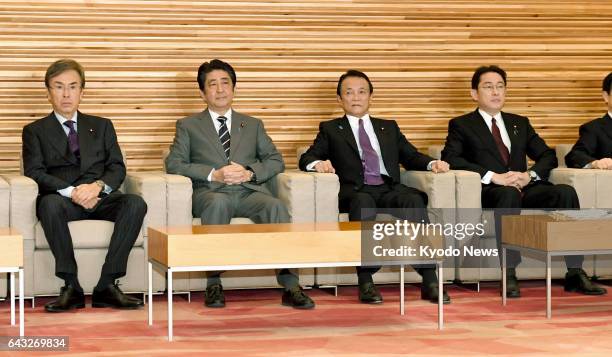 Japanese Prime Minister Shinzo Abe attends a regular Cabinet meeting in Tokyo on Feb. 21 alongside Nobuteru Ishihara , minister in charge of economic...