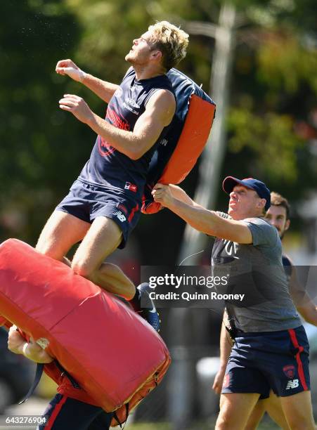 Jack Watts of the Demons marks as head coach Simon Goodwin hits him with a padded bag during a Melbourne Demons AFL training session at Gosch's...