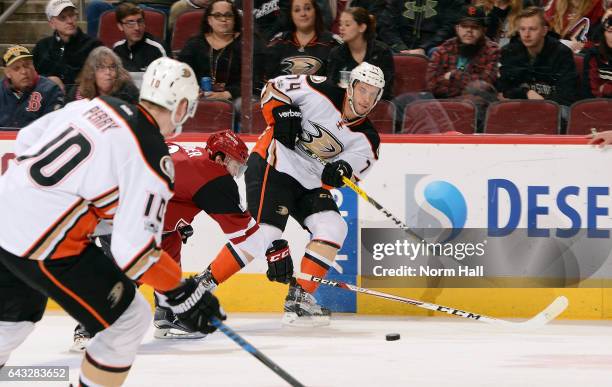 Joseph Cramarossa of the Anaheim Ducks passes the puck to teammate Corey Perry as Tobias Rieder of the Arizona Coyotes defends during the first...