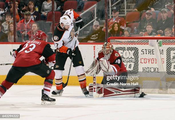 Ryan Kesler of the Anaheim Ducks attempts to re-direct the puck past goalie Marek Langhamer of the Arizona Coyotes as AlexGoligoski of the Coyotes...