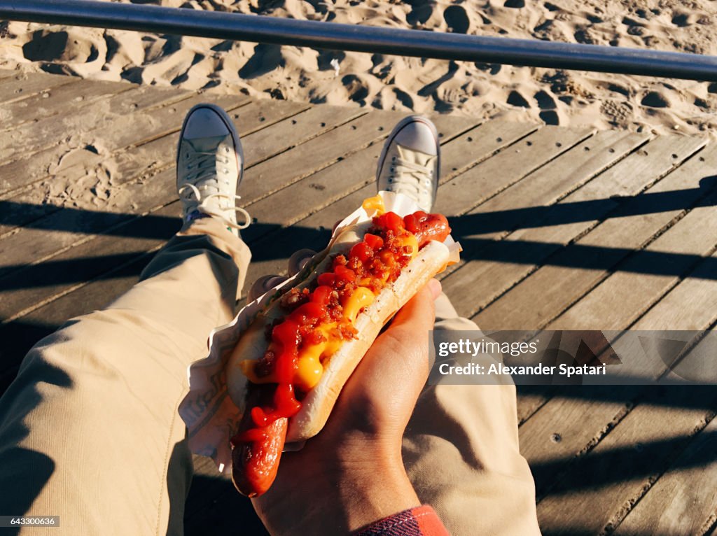 Eating famous New York hot dog at Coney Island Boardwalk, personal perspective