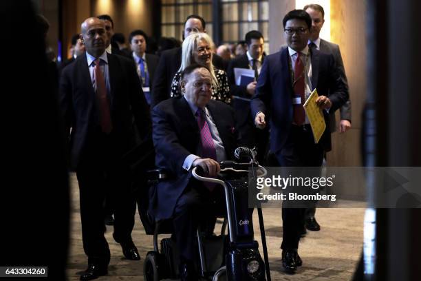 Billionaire Sheldon Adelson, chairman and chief executive officer of Las Vegas Sands Corp., front, arrives for a keynote presentation session at the...