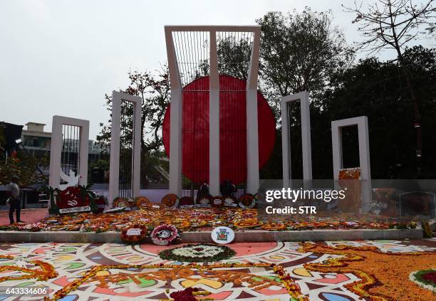 Bangladeshi youth decorate the Bangladesh Central Language Martyrs' Memorial monument with flowers in homage to the martyrs of the 1952 Bengali...