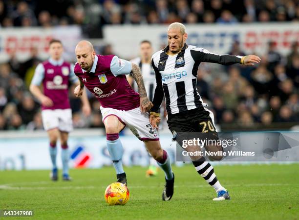 Alan Hutton of Aston Villa is challenged by Yoan Gouffran of Newcastle United during the Sky Bet Championship match between Newcastle United and...