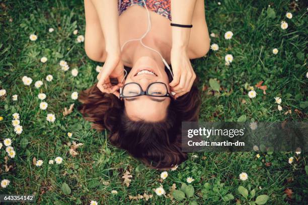 happy girl enjoying the music - reading glasses top view stock pictures, royalty-free photos & images