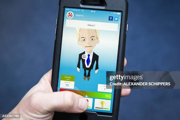 Photo taken in Rijswijk on February 21, 2017 shows a person using the mobile application Kamergotchi, where users are randomly assigned a leader of...