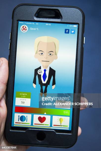 Photo taken in Rijswijk on February 21, 2017 shows a person using the mobile application Kamergotchi, where users are randomly assigned a leader of...