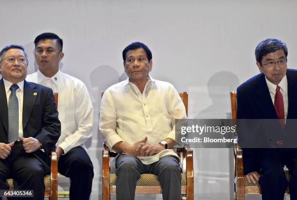 Rodrigo Duterte, the Philippines' president, center, Carlos Dominguez, the Philippines' secretary of finance, left, and Takehiko Nakao, president of...
