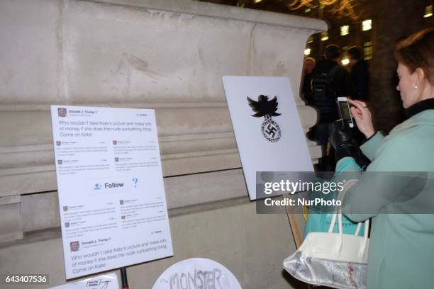 Protesters hold up placards during a rally in Parliament Square against US president Donald Trump's state visit to the UK on February 20, 2017 in...