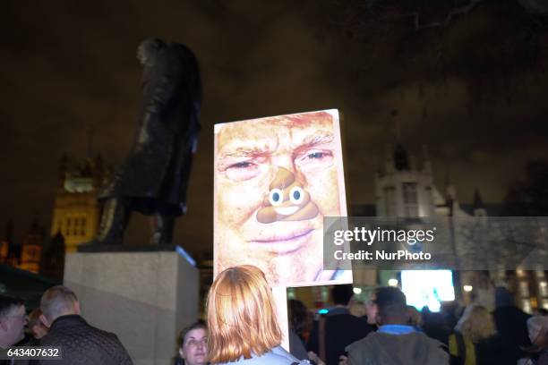 Protesters hold up placards during a rally in Parliament Square against US president Donald Trump's state visit to the UK on February 20, 2017 in...