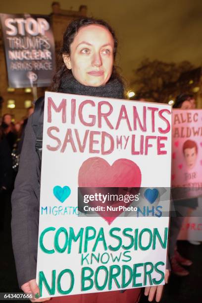 Protesters hold up placards during a rally in Parliament Square against US president Donald Trump's state visit to the UK on February 20, 2017 in...