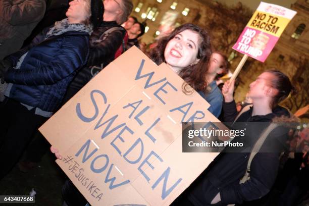 Protesters hold up placards during a rally in Parliament Square against US president Donald Trump's state visit to the UK on February 20, 2017 in...